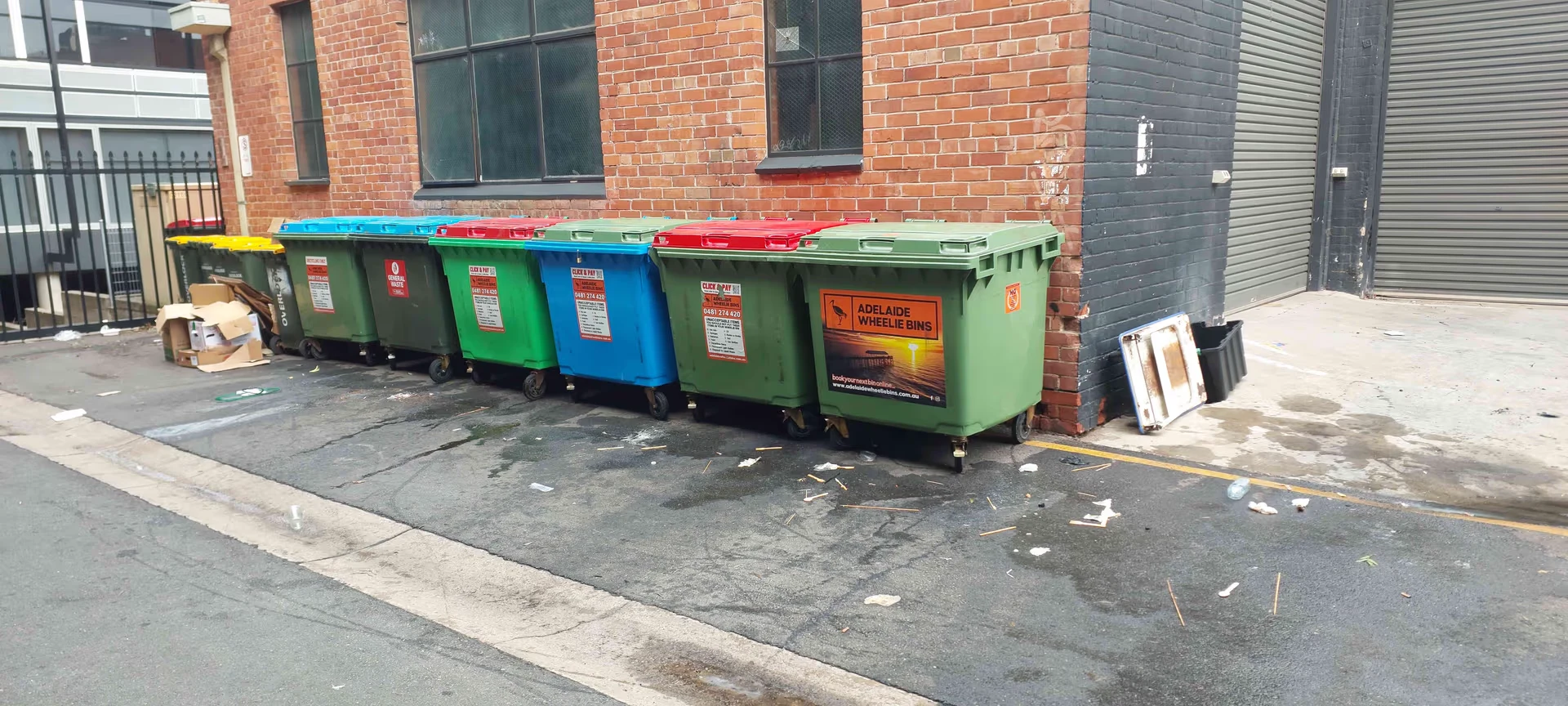 Adelaide Wheelie Bins lined up behind a local business for collection
