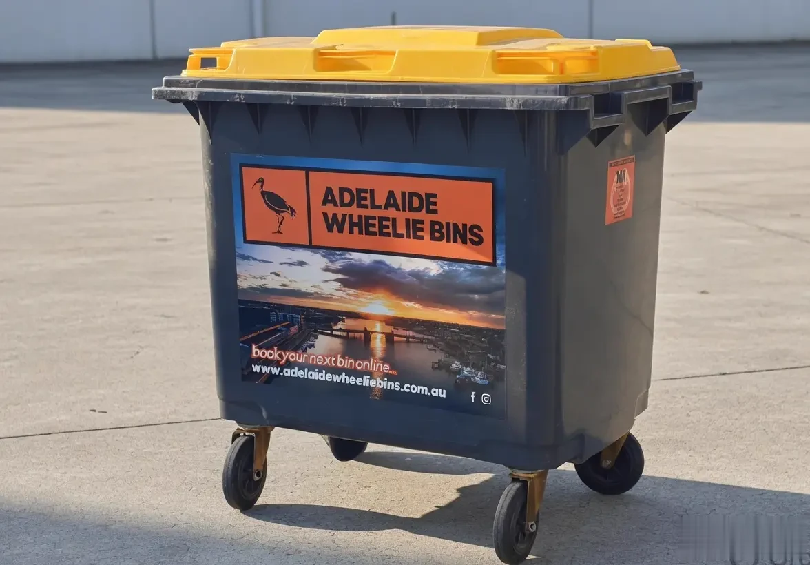 An Adelaide Wheelie Bins 660 litre bin with the orange ibis sticker on its flank